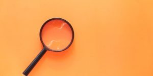 Orange Background Magnifying Glass