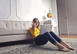 lady sat on floor thinking about the Benefits Of Paid Social Media