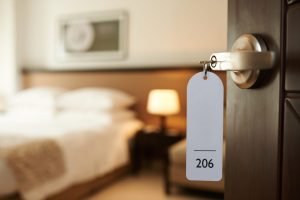 hotel key hanging out of room door. video production