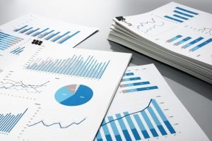 Reports with charts spread across a table