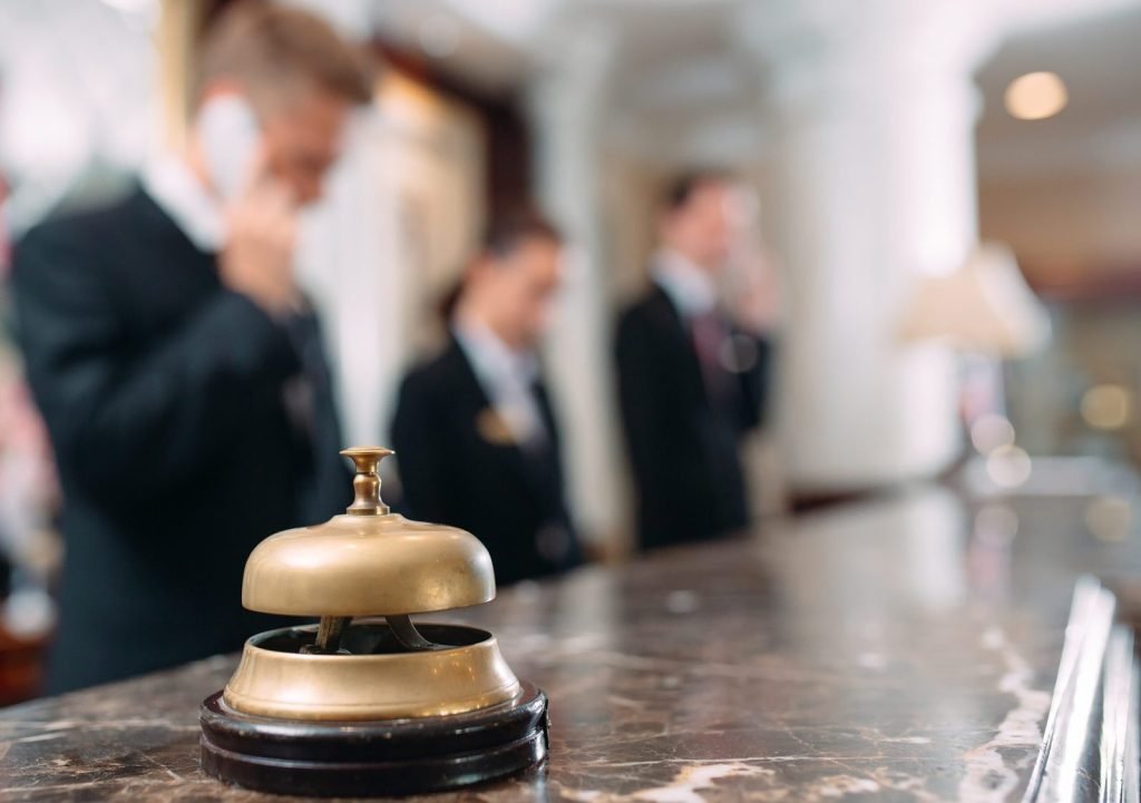 Bell on hotel reception desk. Hospitality industry.