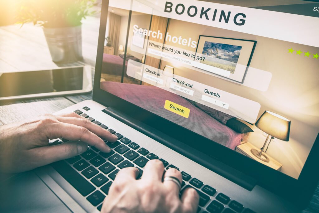 person making hotel booking on laptop