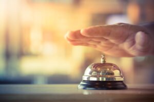 hand hovering over till bell symbolising hospitality