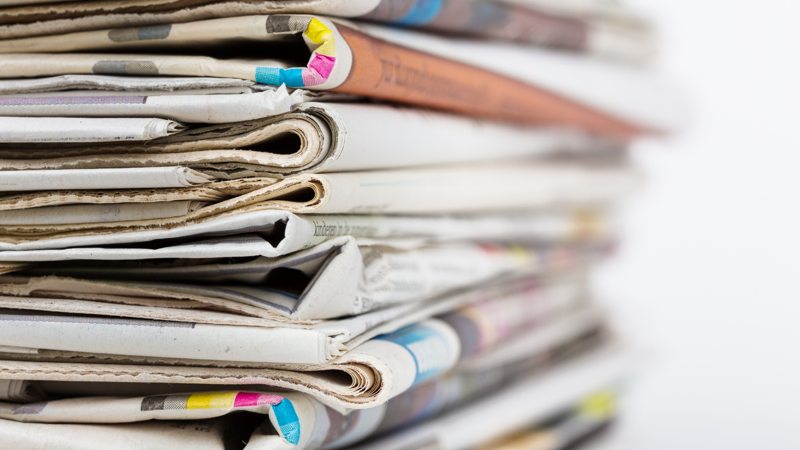 pile of folded newspapers